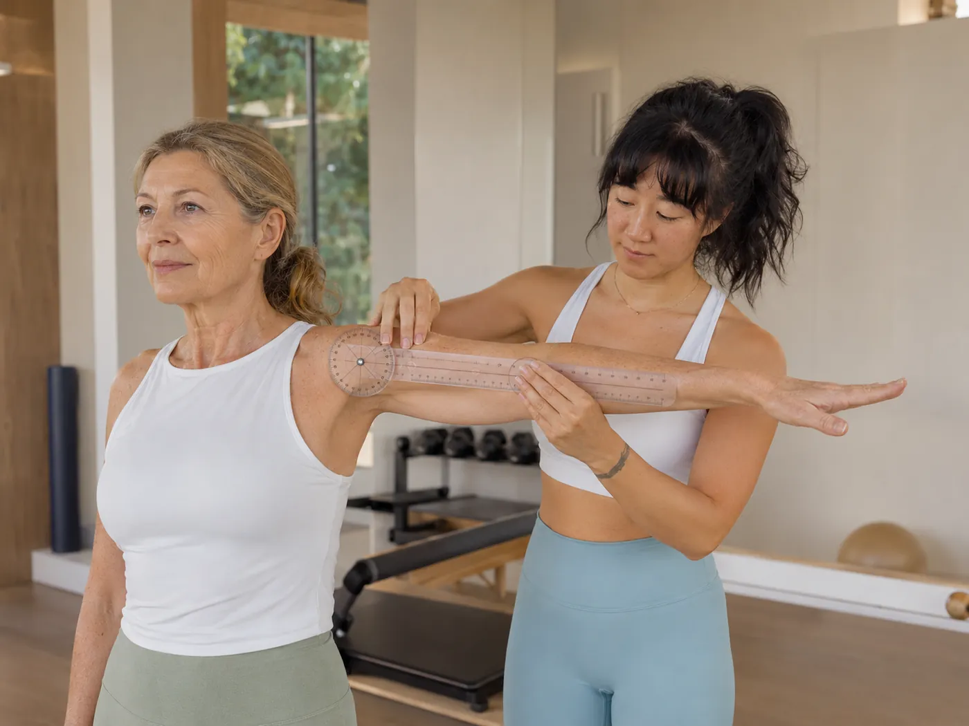 Julie carefully measuring joint mobility during a client assessment